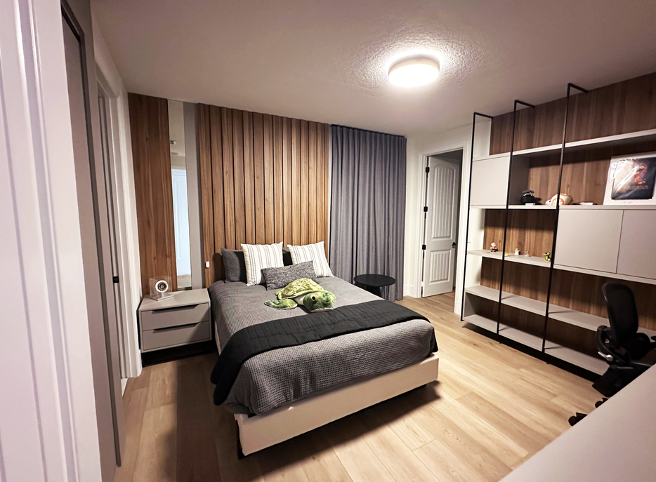 Contemporary Bedroom with Wood Slat Wall and Built-in Shelving